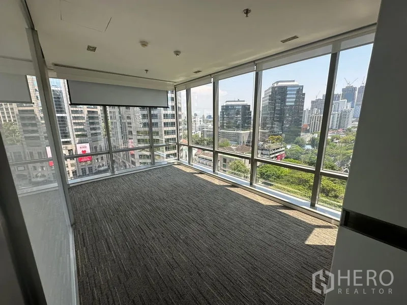 Office Space for rent - Corner meeting room with wraparound floor-to-ceiling windows providing panoramic city views.