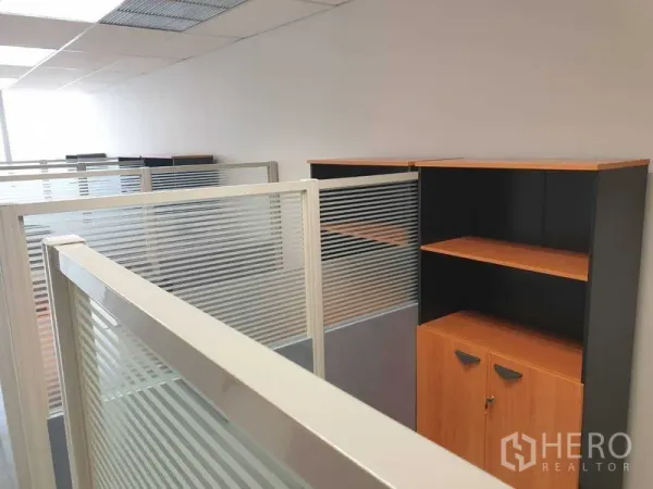 Office Space for rent in Chatuchak, Bangkok - Frosted glass-partitioned cubicles with shelving along the corridor.