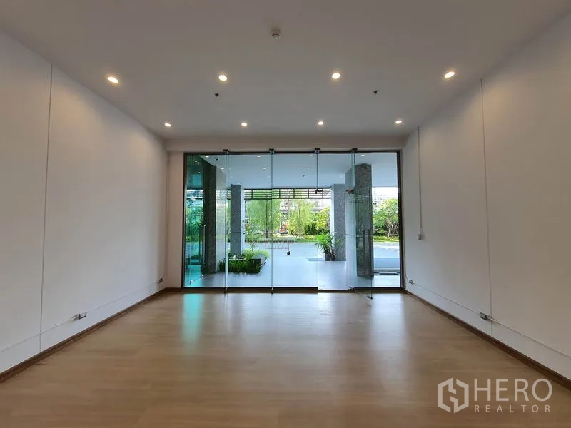 Retail Space for rent in Watthana, Bangkok - Floor-to-ceiling glass storefront opening to a landscaped ground-level frontage.