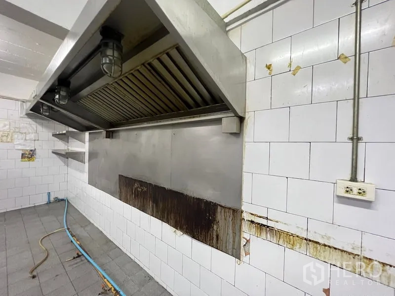 Shophouse for rent - Commercial kitchen exhaust hood on a white tiled wall ready for fit-out.