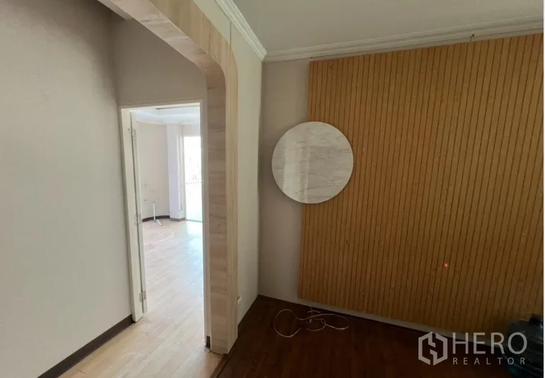 Retail Space for rent - Hallway view toward a bright studio beyond the arched entrance.
