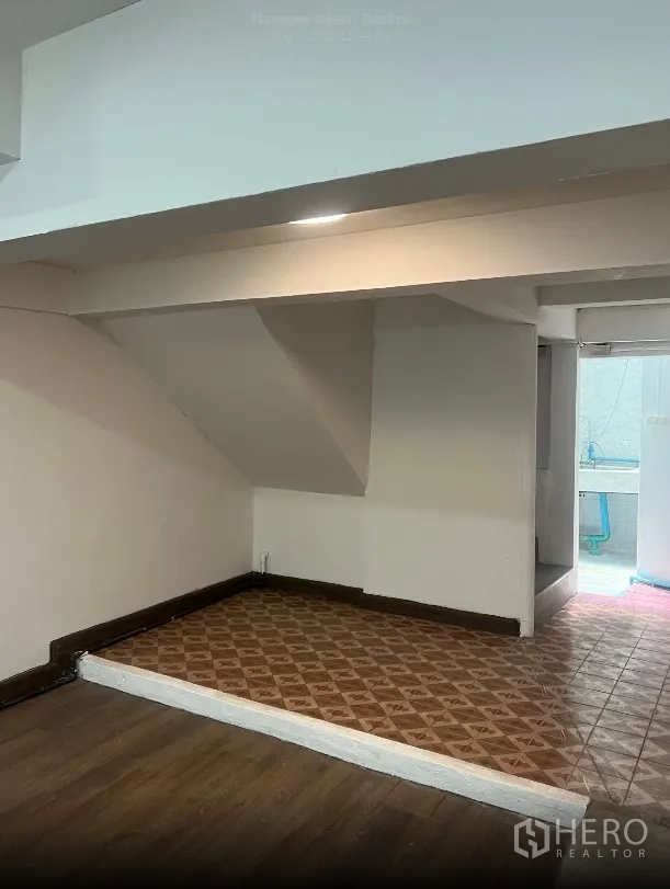 Shophouse for rent in Watthana, Bangkok - Raised platform beneath the staircase with patterned tiles leading to the rear area