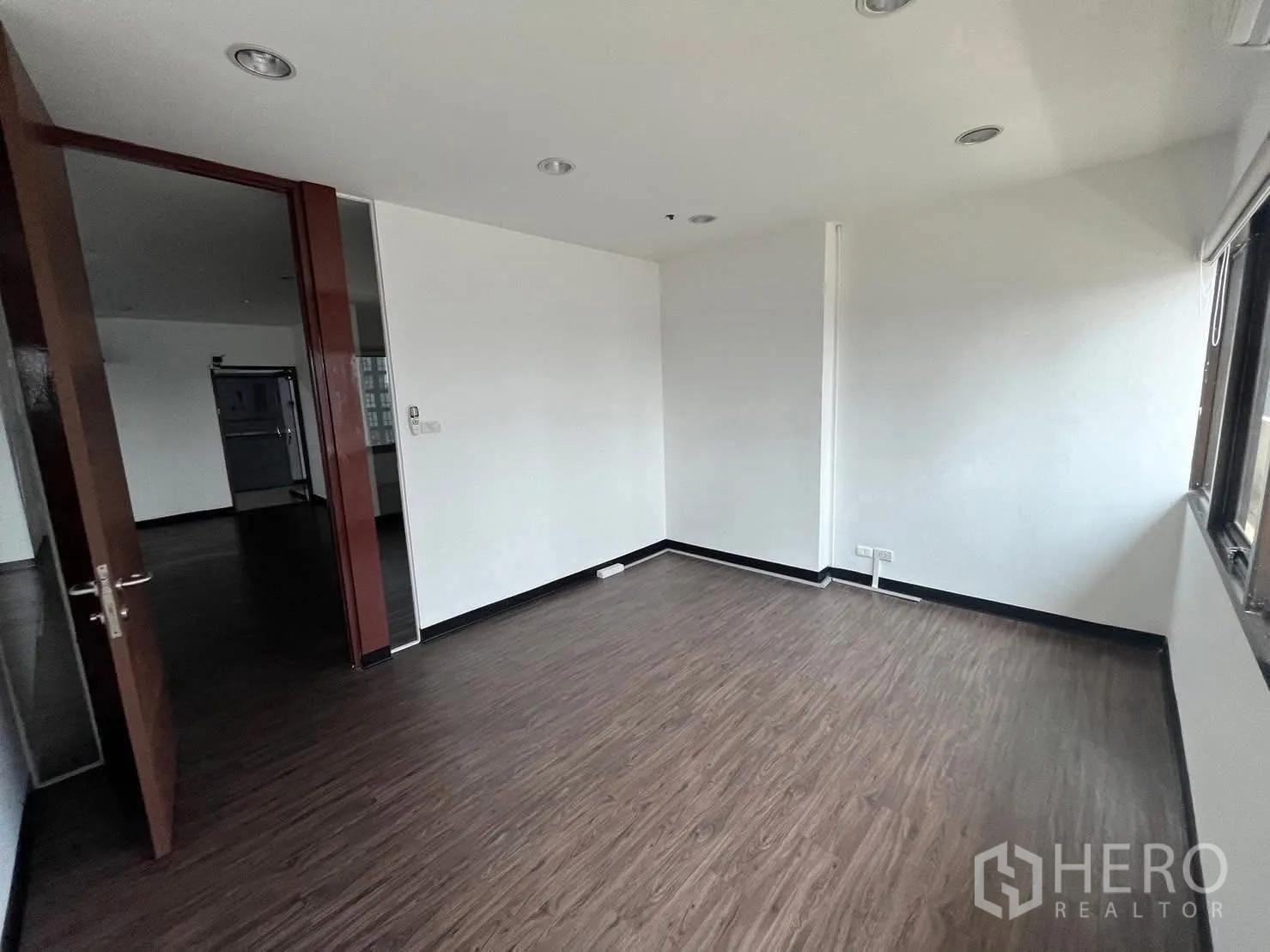 Office Space for rent in Watthana, Bangkok - Small private room off the main space with wooden door and a large window.